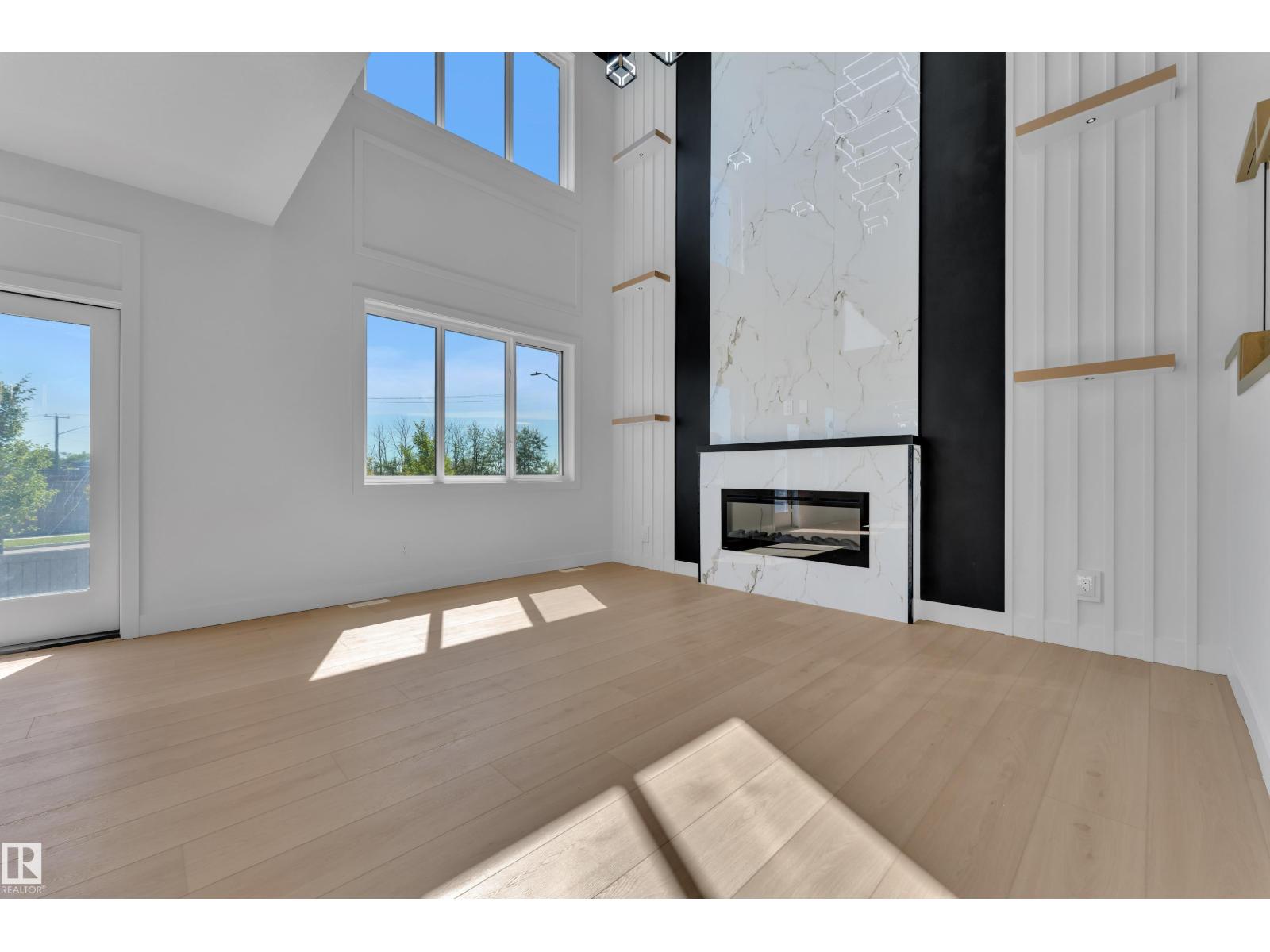 Open-to-above great room with fireplace feature wall