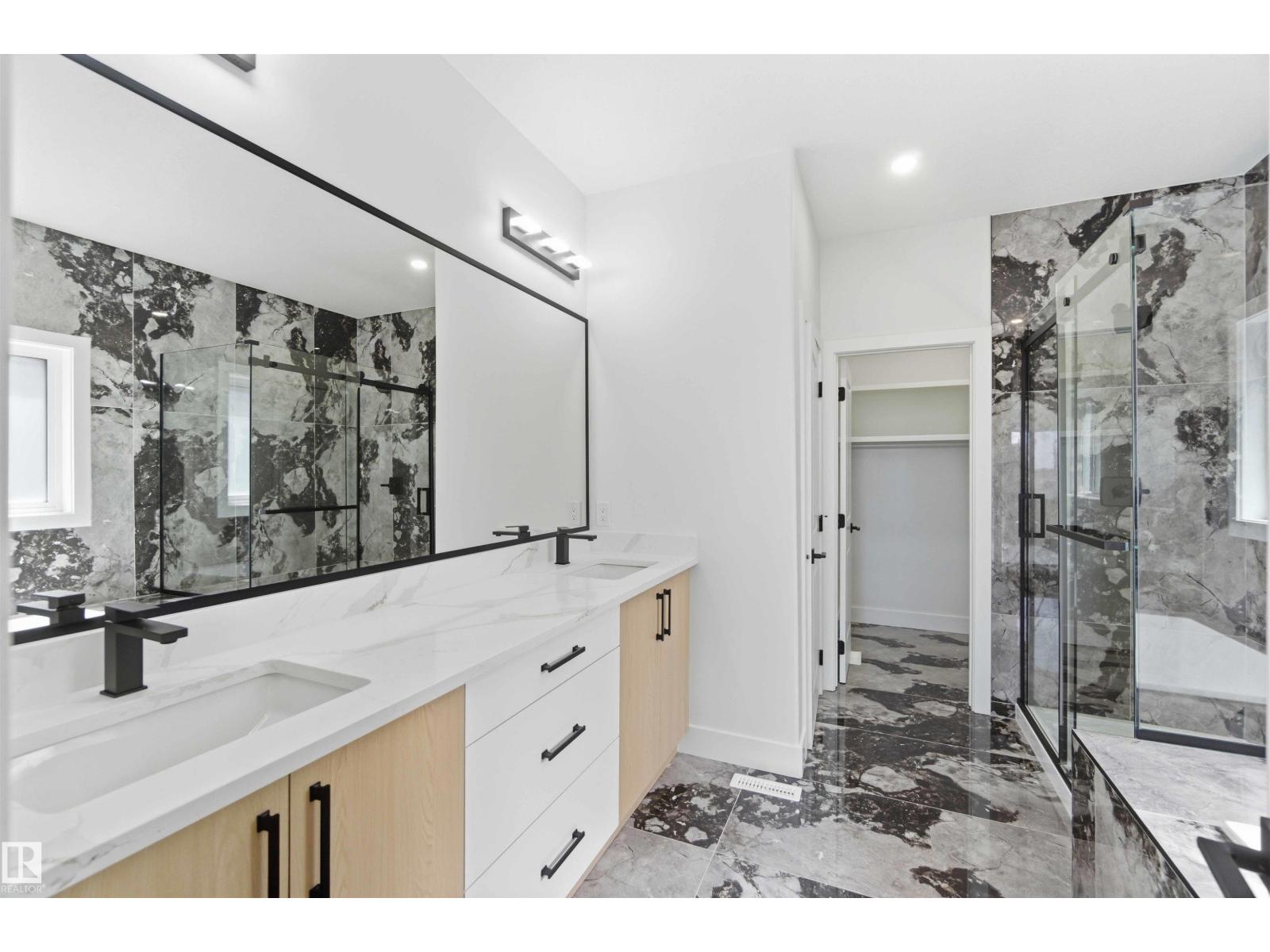 Primary ensuite with dark stone shower
